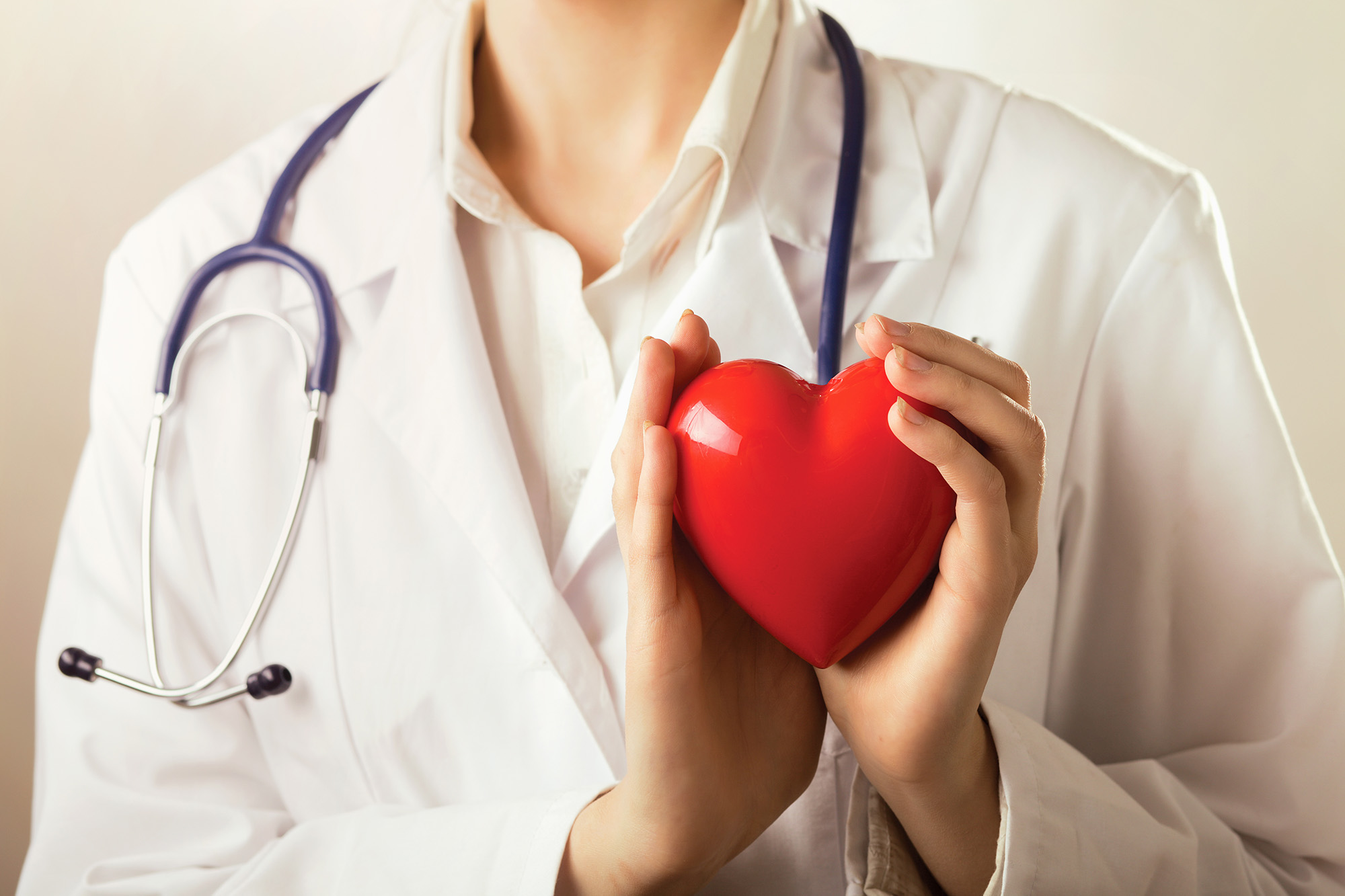 Female,Doctor,With,Stethoscope,Holding,Heart,,Isolated,On,White,Background
