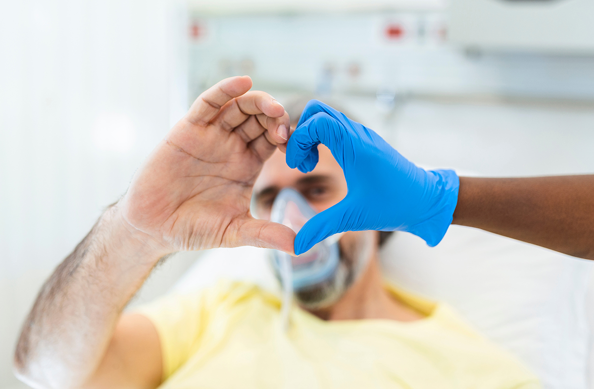 Doctor,And,Patient,Make,Finger,Heart,Shape,Wearing,Blue,Disposable