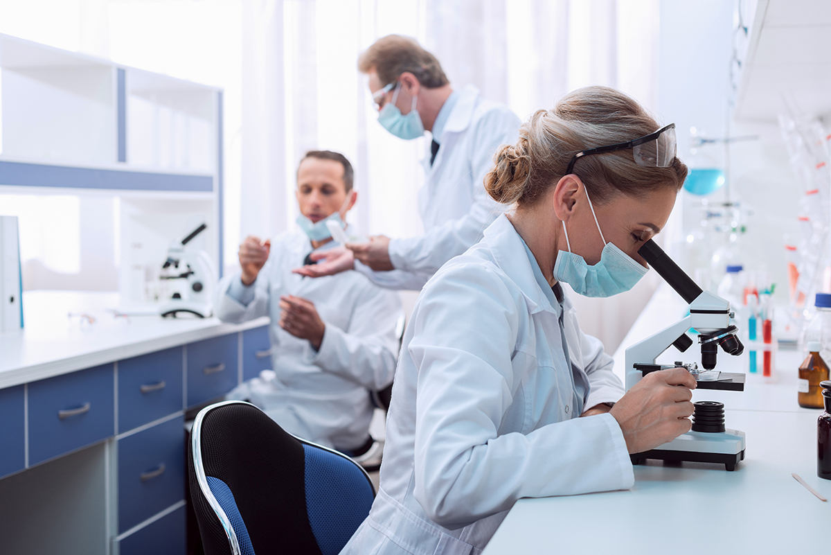 Medical,Worker,In,Lab,Coat,And,Sterile,Mask,,Doing,A